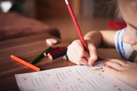 close up of girl writing - past tense